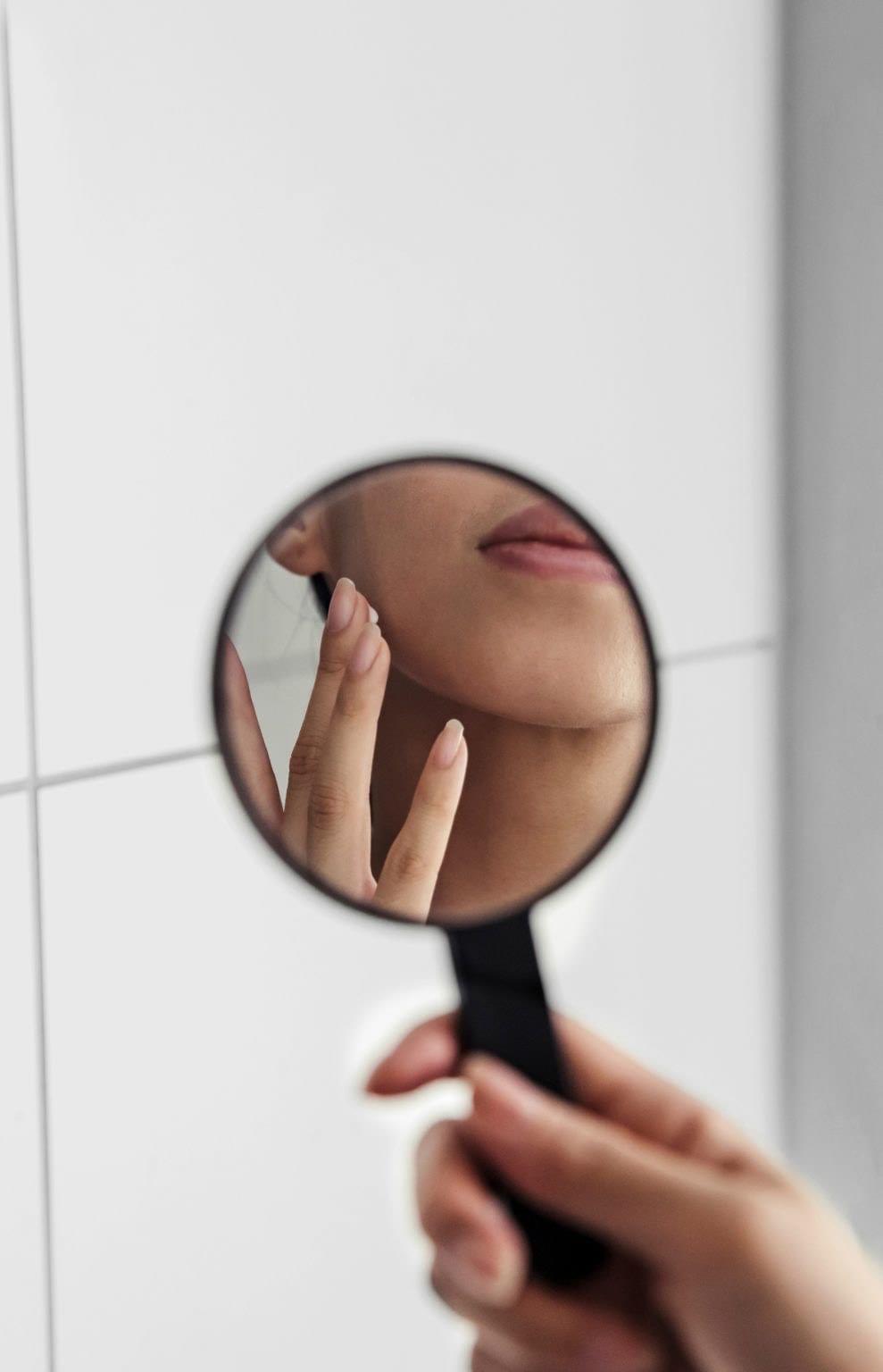 Chica aplicándose crema en el rostro